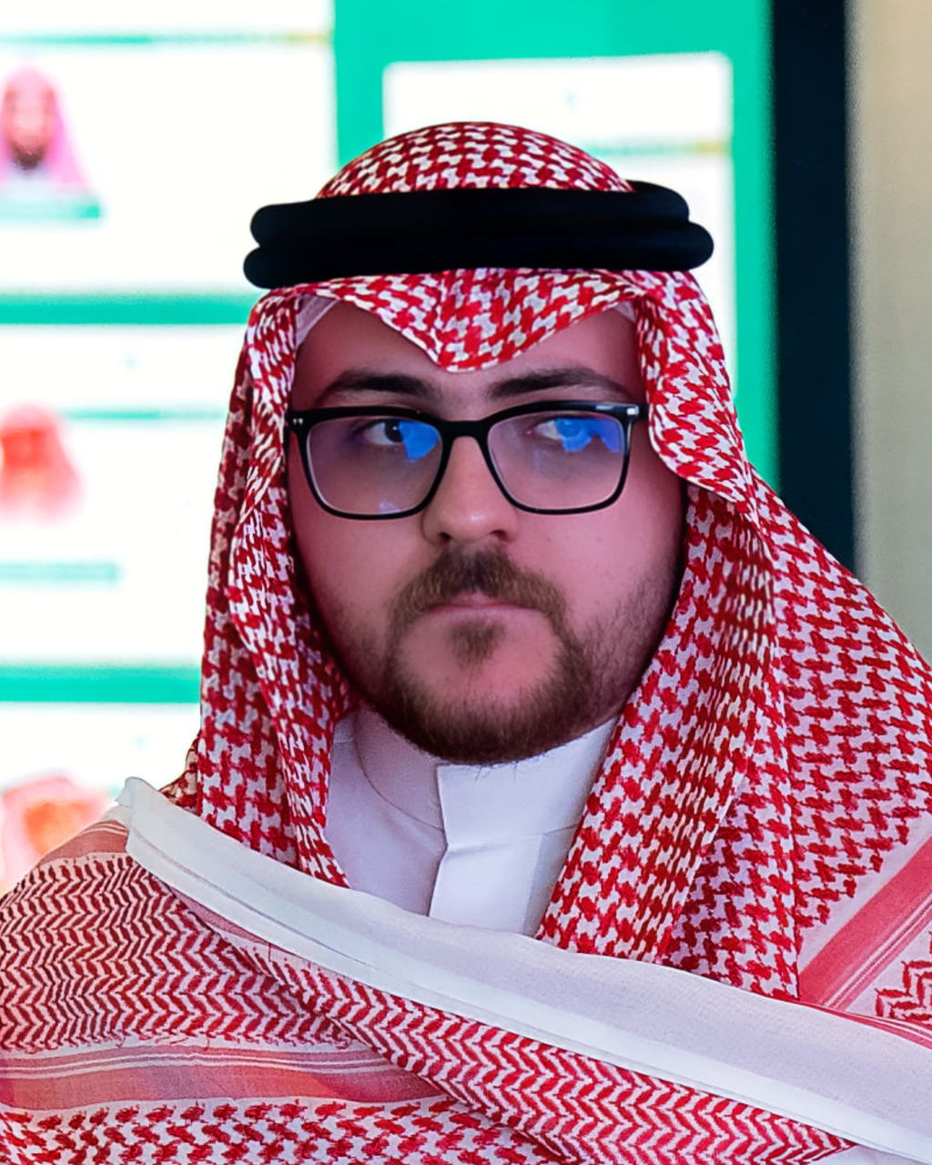 Faris Bisher, President of Horizon Studio, in a keffiyeh and glasses, looking past the camera.