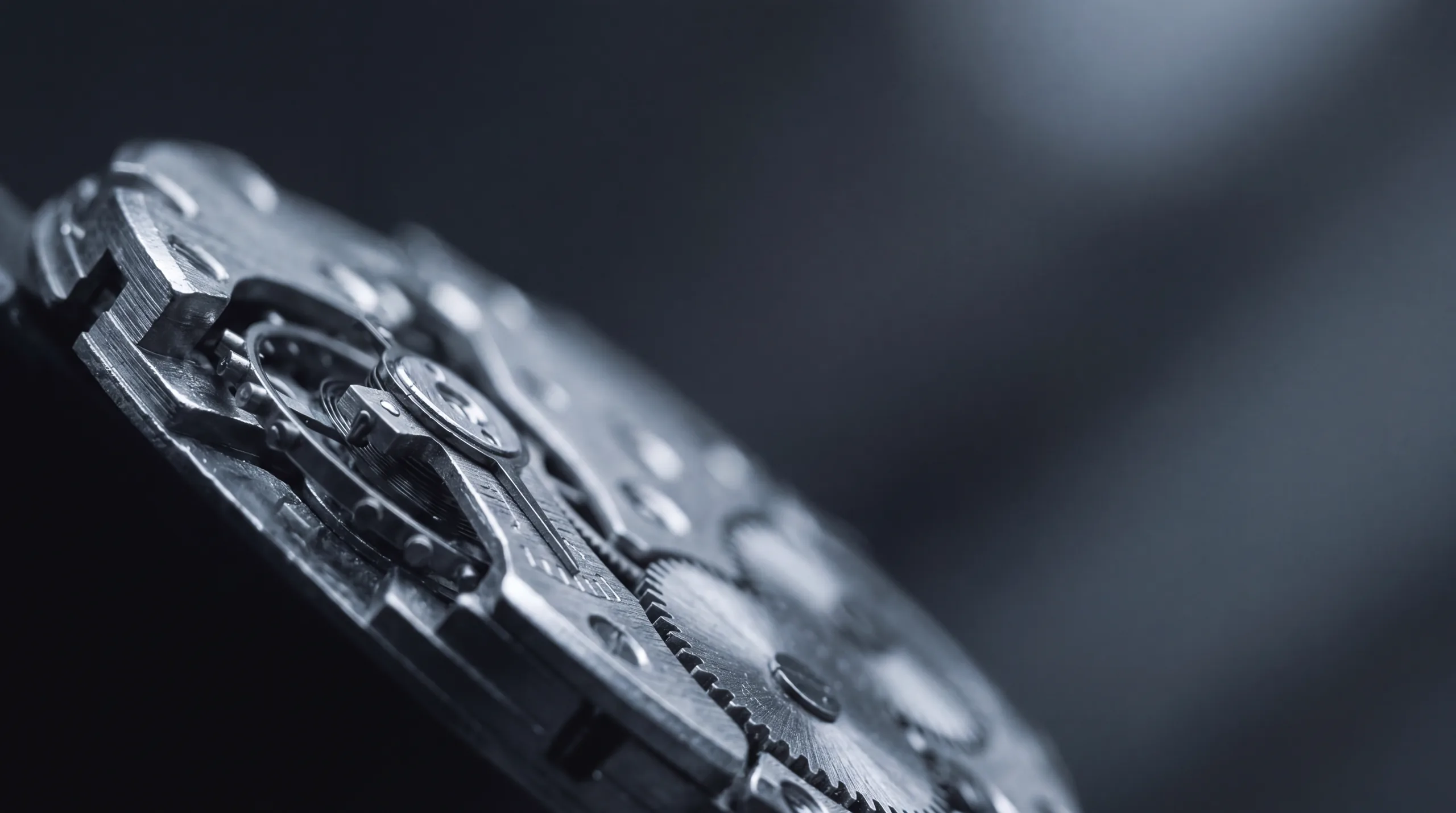 Macro view of a mechanical watch movement, gear teeth and jewels in shallow focus.