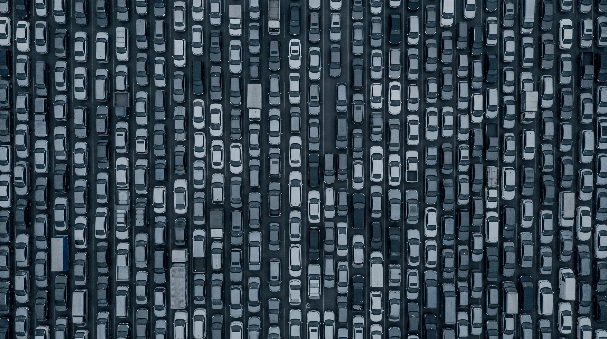 An aerial grid of stationary vehicles packed lane by lane, seen from directly above.